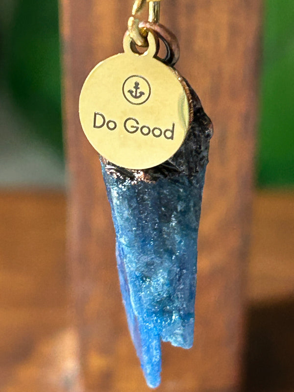 Blue kyanite pendant with Do Good charm. Goldtone paperclip chain. 